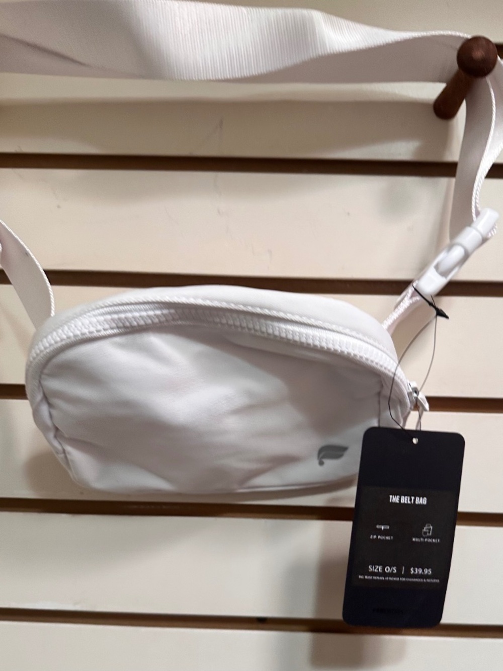 Fabletics The Belt Bag in classic white featuring a minimalist silver logo and a